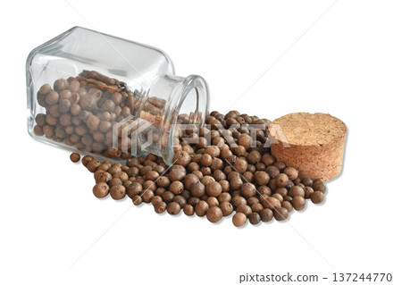 Dry allspice in a glass container. 137244770