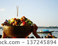Traditional brass bowl filled with fruits and incense offerings for Chhath Puja festival on the Ganges river 137245894