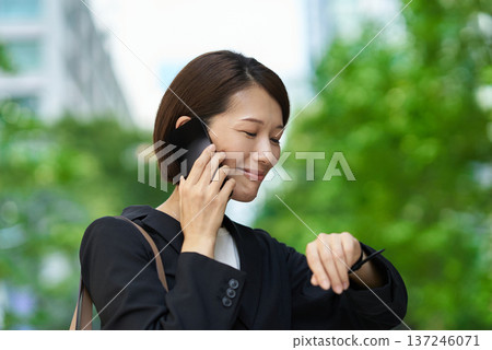 A businesswoman who seems to be concerned about time A businesswoman who seems to be concerned about time 137246071