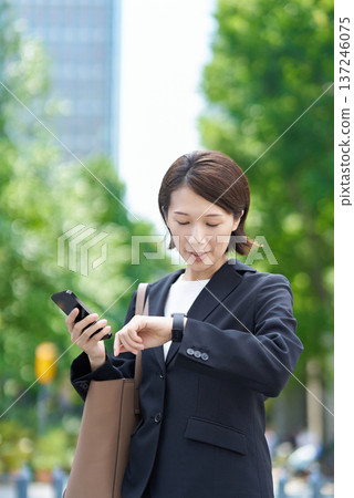 A businesswoman who seems to be concerned about time A businesswoman who seems to be concerned about time 137246075