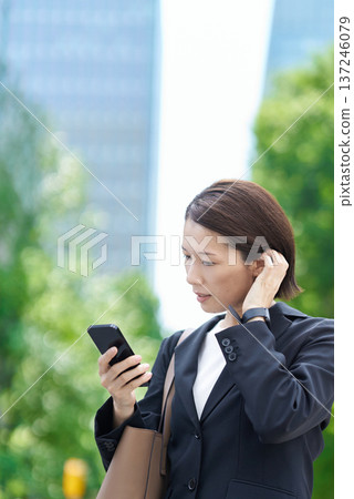 A businesswoman who seems to be concerned about time A businesswoman who seems to be concerned about time 137246079