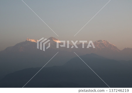 A landscape of the Himalayan ranges illuminated by the morning sun and silhouettes of the mountains in the foreground A landscape of the Himalayan ranges illuminated by the morning sun and silhouettes of the mountains in the foreground 137246219