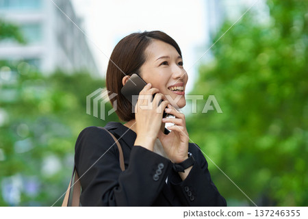 Businesswoman talking on a smartphone Businesswoman talking on a smartphone 137246355