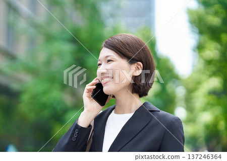 Businesswoman talking on a smartphone Businesswoman talking on a smartphone 137246364