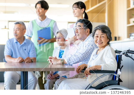 Young helpers and seniors cuddling at a nursing home 137246395