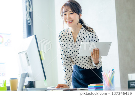A young woman working in the office A young woman working in the office 137246439
