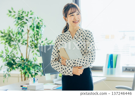 A young woman working in the office 137246446