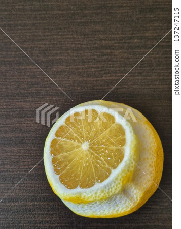 A close-up of a cut lemon, showing off its juicy flesh and bright yellow texture. A close-up of a cut lemon, showing off its juicy flesh and bright yellow texture. 137247115