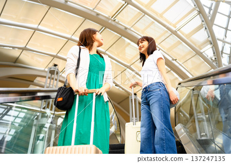 Two women having a conversation at the airport. Photo courtesy of Kansai International Airport (KIX). Two women having a conversation at the airport. Photo courtesy of Kansai International Airport (KIX). 137247135