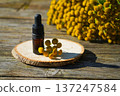 tansy essential oil in a beautiful bottle on the table 137247584
