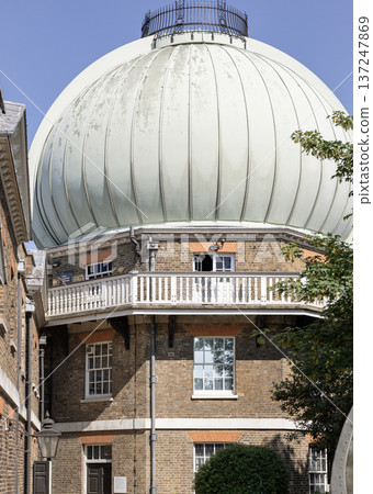 The Great Equatorial Building, crowned by its iconic onion dome, serves as a prominent landmark within the Royal Observatory Greenwich. The Great Equatorial Building, crowned by its iconic onion dome, serves as a prominent landmark within the Royal Observatory Greenwich. 137247869