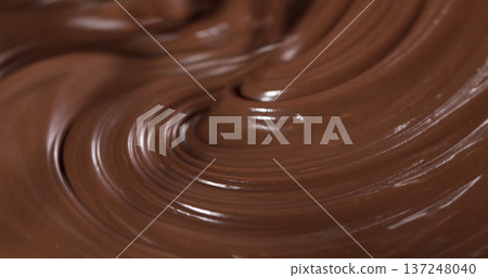 Chocolate being mixed in a bowl during a dessert preparation in a kitchen setting at midday Chocolate being mixed in a bowl during a dessert preparation in a kitchen setting at midday 137248040