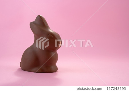 Chocolate Easter eggs and colorful sweets on a pink background. 137248393
