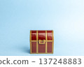 A red treasure chest placed on a light blue background 137248883