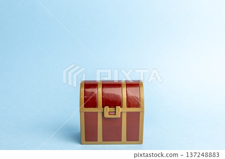 A red treasure chest placed on a light blue background A red treasure chest placed on a light blue background 137248883