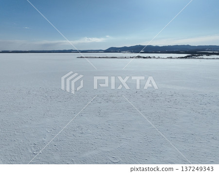 Aerial photo of Lake Saroma and Cape Kimuaneppu snow fields in winter 137249343