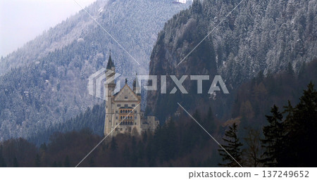 Neuschwanstein Castle stands tall among snow-covered mountains in Bavaria during winter season 137249652