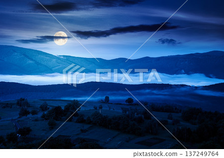 mountainous rural area during springtime at night. full moon over remote mountain landscape with forested rolling hills. mysterious foggy place of alpine countryside wallpaper 137249764