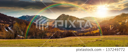 sunset over wonderful panorama of a countryside landscape in springtime. beautiful view of mountainous rural area with forested hill. rolling alpine scenery with settlement in the valley under rainbow sunset over wonderful panorama of a countryside landscape in springtime. beautiful view of mountainous rural area with forested hill. rolling alpine scenery with settlement in the valley under rainbow 137249772