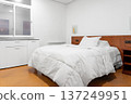 Hotel bedroom with central bed and plastic window. Simple cozy living space 137249951