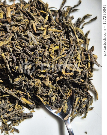 green tea leaves on white background. green tea leaves green tea leaves on white background. green tea leaves 137250045