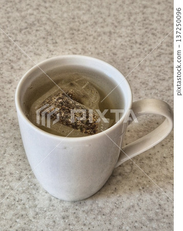packaged herbal tea brewed in a cup 137250096