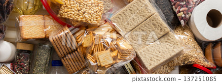 Essential home food stock for military operations and crises and for the period of quarantine and isolation, canned food, pasta, flour and nonperishable items,the concept of stay at home, banner Essential home food stock for military operations and crises and for the period of quarantine and isolation, canned food, pasta, flour and nonperishable items,the concept of stay at home, banner 137251085