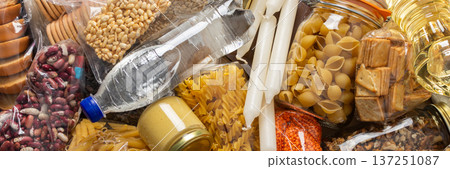 Essential home food stock for military operations and crises and for the period of quarantine and isolation, canned food, pasta, flour and nonperishable items,the concept of stay at home, banner Essential home food stock for military operations and crises and for the period of quarantine and isolation, canned food, pasta, flour and nonperishable items,the concept of stay at home, banner 137251087