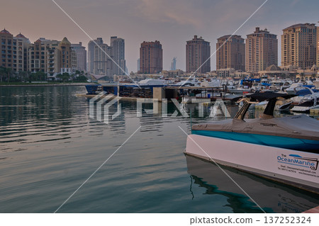 Doha, Qatar- November 15 2025: Porto Arabia Marina in The pearl sunset shot showing luxurious yachts and boats docked at the marina . Doha, Qatar- November 15 2025: Porto Arabia Marina in The pearl sunset shot showing luxurious yachts and boats docked at the marina . 137252324