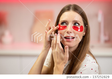 Pretty long-haired woman having beauty procedures and using eye patches 137252829