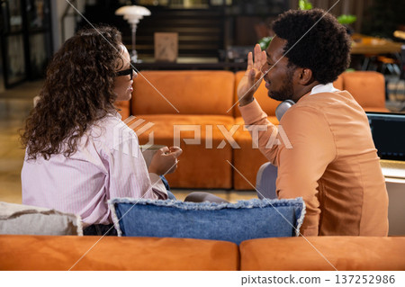 Professional woman talking with man posing during meeting in office interior Professional woman talking with man posing during meeting in office interior 137252986