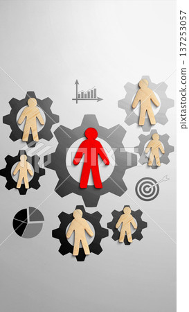 Central red human figure stands in a gear, surrounded by wooden team members in cogs alongside icons for charts and targets. Represents leadership, organizational structure, and performance management 137253057
