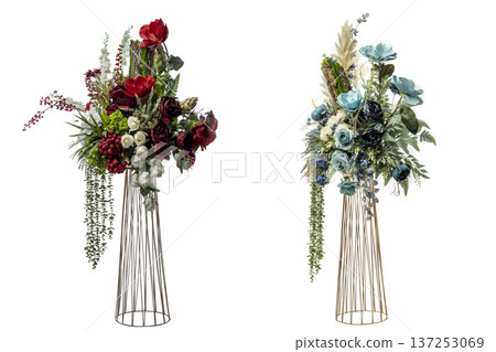 Sophisticated artificial floral arrangements on tall gold wire stands. One features red and white blooms, the other teal and blue flowers. Perfect for wedding, event, or high-end home decor 137253069