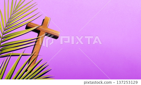 Wooden cross rests on green palm branches against a vibrant purple background. This symbolic composition represents Christian observance of Palm Sunday, Lent, and the Easter season with copy space Wooden cross rests on green palm branches against a vibrant purple background. This symbolic composition represents Christian observance of Palm Sunday, Lent, and the Easter season with copy space 137253129