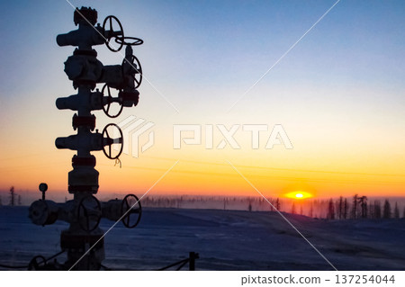 Oil well against the backdrop of sunset. industrial landscape 137254044