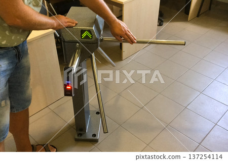 Testing turnstile at the entrance. Pass through the turnstile. Testing turnstile at the entrance. Pass through the turnstile. 137254114