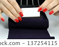 business card in women's hands with a manicure. business card 137254115
