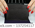 The purse is a businesswoman in women's hands with makeup. 137254117