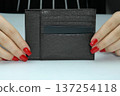 The purse is a businesswoman in women's hands with makeup. 137254118