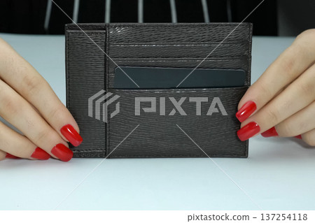 The purse is a businesswoman in women's hands with makeup. The purse is a businesswoman in women's hands with makeup. 137254118
