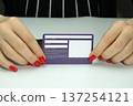business card in women's hands with a manicure. business card 137254121