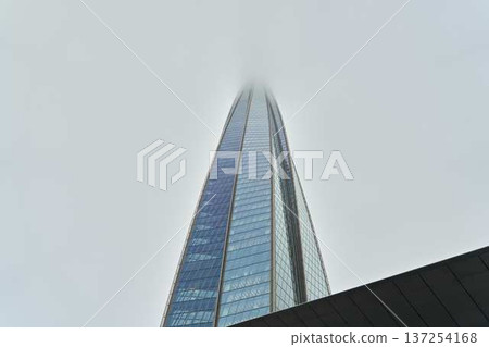 Urban highrise merges into cloudy sky with sleek modern design Urban highrise merges into cloudy sky with sleek modern design 137254168