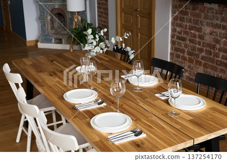 Intimate meal setting featuring rustic decor and fresh flowers 137254170