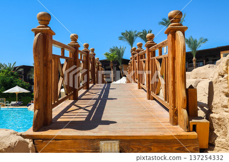 Wooden bridge over the hotel swimming pool Wooden bridge over the hotel swimming pool 137254332