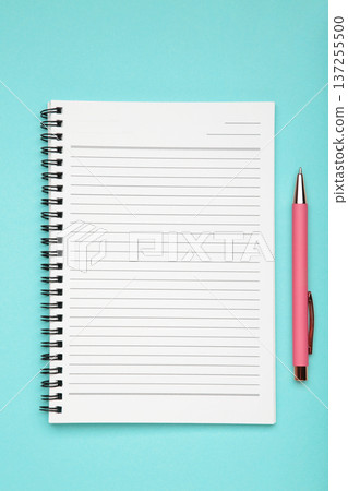 Open notepad and pen on blue background. Space for writing. Open notepad and pen on blue background. Space for writing. 137255500