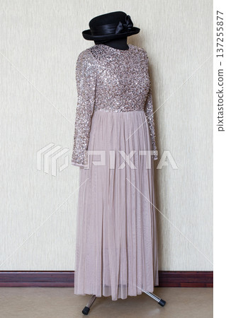 A beautiful women's dress on a mannequin with a hat A beautiful women's dress on a mannequin with a hat 137255877