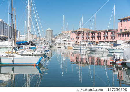 Modern harbor with boats and waterfront buildings. Concept of urban development, seaside property and marine industry. Modern harbor with boats and waterfront buildings. Concept of urban development, seaside property and marine industry. 137256308