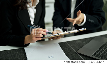 Business consulting. People discussing the charts and graphs showing the results of their successful teamwork Business consulting. People discussing the charts and graphs showing the results of their successful teamwork 137256644
