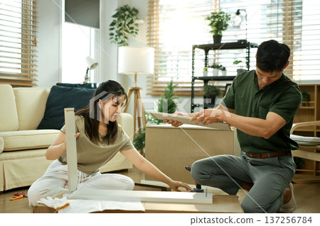 Photo series of young asian couple assembly a new furniture at home 137256784
