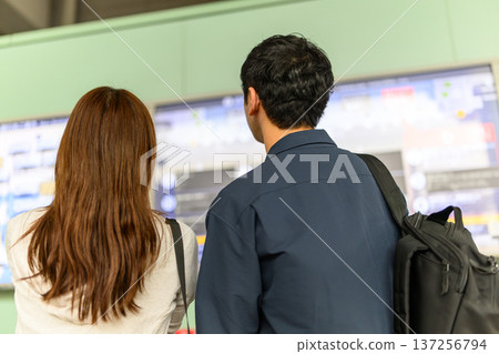 一對夫婦正在觀看機場的電子顯示器。照片由關西國際機場（KIX）提供。 137256794